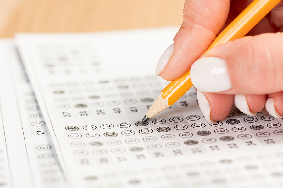 Close up of nurse educator student's hands as they fill out a multiple choice test form.