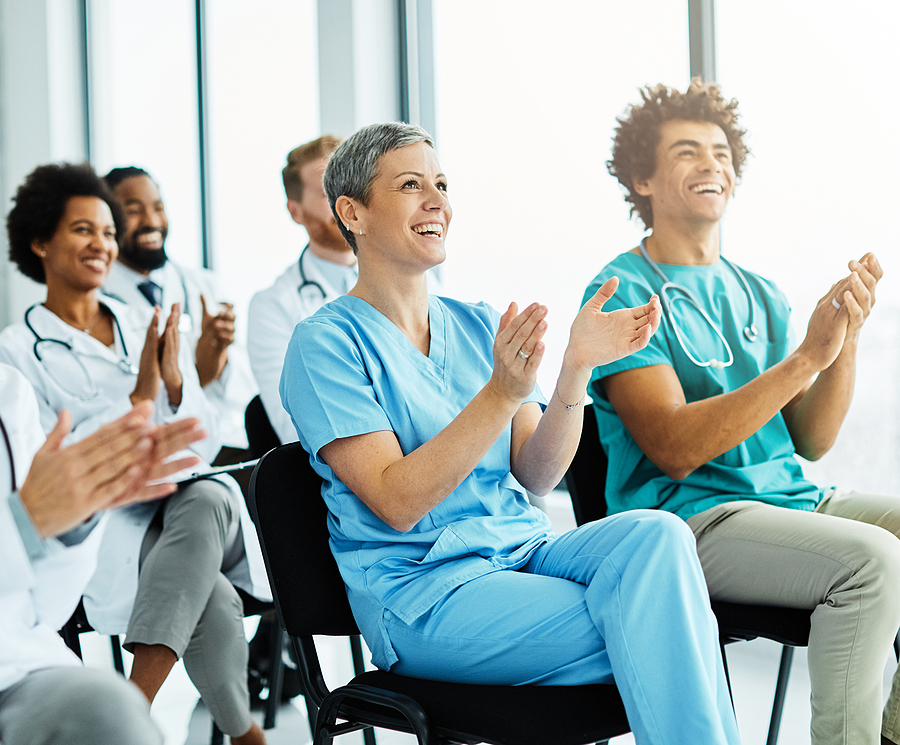 Room of nurses listening to a nurse educator's teaching seminar.