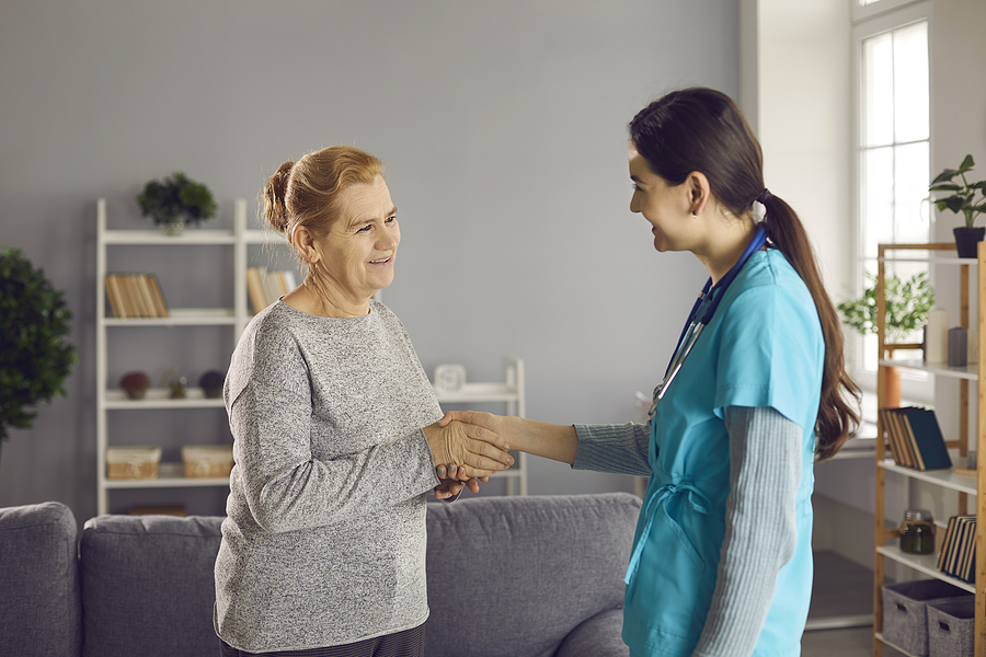 Nurse Educator greeting patient in medical office lobby.