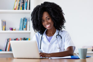 Nursing student on laptop working on DNP degree